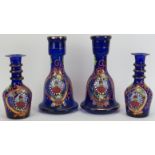 Four Persian gilt enamel painted blue glass bottles, late 19th/early 20th century. Each depicting