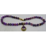 A rare and unusual Russian sugilite bead necklace with yellow metal amethyst pendant. Amethyst