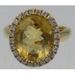 An 18ct yellow gold citrine & diamond ring. Citrine approx 15mm x 10mm, 23 diamonds approx 0.20ct,