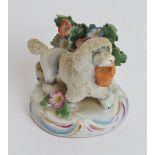 A French Sampson ceramic poodle with basket, 19th century. Modelled after Chelsea porcelain with
