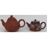 Two Chinese yixing teapots. The larger teapot with impressed seal mark and the smaller overglaze