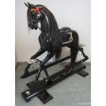 A Stevenson Brothers Ferrari Scuderia themed ebonized oak rocking horse. This full sized horse