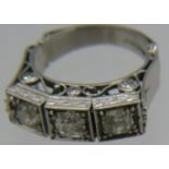 A fine platinum & diamond ring. The three central brilliant cut diamonds in square setting, approx