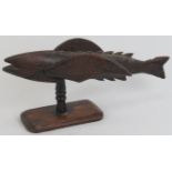 A Pitcairn Islands carved hardwood flying fish on stand. A souvenir from the Pitcairn Islands