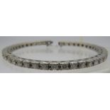 A fine white metal bangle set with 43 diamonds, each approx 0.15cts, approx weight 28 grams. NB: