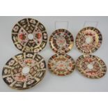 A group of English Imari pattern porcelain saucers. Comprising four matching Royal Crown Derby