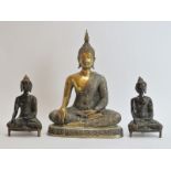 Three Chinese brass and bronze Buddhas, 20th century. Comprising a large brass Buddha together