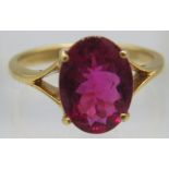 An 18ct yellow gold ring set with an oval cut Shimoyo rubellite, approx 11mm x 8mm, approx weight 49