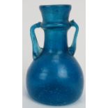 A Roman turquoise blue glass miniature amphora. 3.2 in (8 cm) height. Condition report: Good