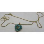 A yellow metal heart shaped turquoise encrusted pendant/locket with a 'V' set with tiny seed