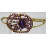 A 9ct yellow gold bangle set with centre marquise cut amethyst approx 12mm x 7mm, which is