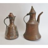 Two Middle Eastern metalwork decanters. Comprising a copper jug of mallet form with hinged cover