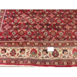 A fine mid 20th century Persian carpet central block pattern on red ground with flowered cream