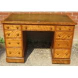 A Victorian birch kneehole desk, the top with inset tooled green leather writing surface, above a