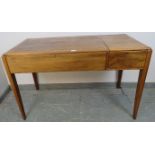 A vintage Art Deco style rosewood writing desk retailed by Heal & Son, having a flip-up stationary