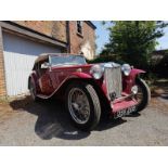 A 1948 MG TC 1250cc roadster, the cranberry red coachwork complimented by a contrasting oatmeal hide