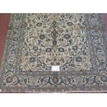 A Persian Yazd carpet cream ground with heavy floral motifs and in good condition. 250cm x 150cm.