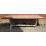 A vintage limed oak refectory table, on rail supports with a middle stretcher painted distressed