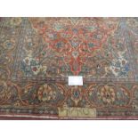A signed Persian Kashan carpet with central motif on burnt amber field. In good condition. 225cm x