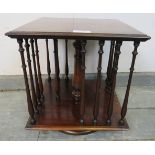 An Edwardian mahogany revolving tabletop bookcase of small proportions, featuring turned side