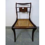 A Regency Period mahogany rope back occasional chair, with brass Boulle work inlay and bergère seat,