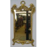 A giltwood wall mirror in the Neo-Classical taste, the acanthus carved cornice with urn finials, the