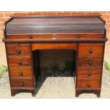 An Edwardian mahogany roll-top desk, the tambour door opening onto a fitted interior, above an array