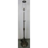 A vintage bronzed height adjustable standard lamp in the Art Nouveau taste, on a circular plinth