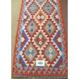 A Chobi Kilim runner, good colours and excellent condition. 204cm x 68cm.