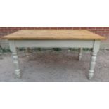 A stripped pine farmhouse kitchen table, with long drawer to one side, on baluster turned supports