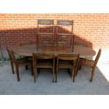 A good quality weathered teak extending outdoor table by Royal Botania, with butterfly folding