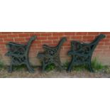 Three pairs of cast iron bench ends painted green, two with scrolled fleur de Lis detail, the