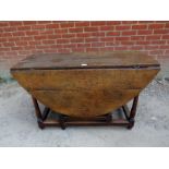 An 18th century oak oval gate-leg table, with single drawer, on tapering supports with stretchers.