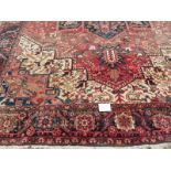 A good quality mid 20th century Persian carpet central star burst motif, on pale red ground with