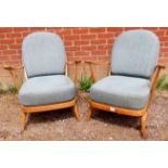 A pair of mid-century elm and beech open sided Windsor armchairs by Ercol (model 203) with loose