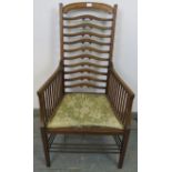 An Edwardian Arts & Crafts Glasgow School mahogany ladder-back elbow chair, attributed to Wylie &