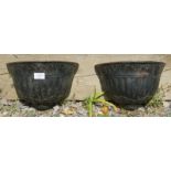 A pair of well-cast vintage cast iron demi lune wall planters, with fluted decoration and frieze