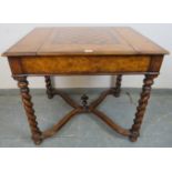 A reproduction burr walnut games table by Theodore Alexander, the sliding central section with