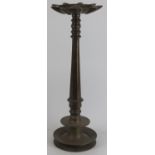 An Indian bronze floor standing temple 'Puja' oil lamp with nine wick diya reservoir, 19th