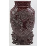 A Chinese sang de boeuf glazed vase, 20th century. Of compressed form with decoration moulded in