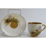 A Royal Worcester gilt polychrome painted porcelain coffee cup and saucer, circa 1914. With a gilt