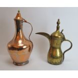 Two Middle Eastern metalwork decanters. Comprising a copper jug with hinged cover together with a