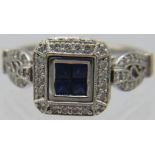 An 18k CN marked white gold square set Art Deco style ring set with four square cut centre