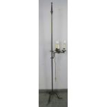 A vintage wrought iron height adjustable standard lamp in the Gothic taste, with top finial and