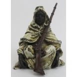 An Austrian style cold painted bronze figure of an Arab with musket. Depicted seated on the ground