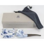 A Royal Copenhagen blue and white porcelain pipe and stand. With a florally decorated bowl and