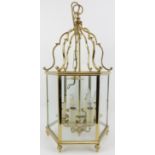 A hexagonal brass hall lantern, 20th century. With six rectangular glass panes. 67 cm height, 99