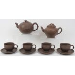 A group of Chinese yixing pottery wares, 20th century. Comprising two teapots together with four