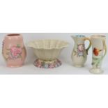 A group of four Clarice Cliff hand decorated and relief moulded pottery wears. Comprising a large