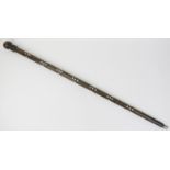 An Indian inlaid fruitwood walking cane, late 19th/20th century. The knop handle and tapered shaft